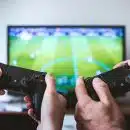 two people playing Sony PS4 game console