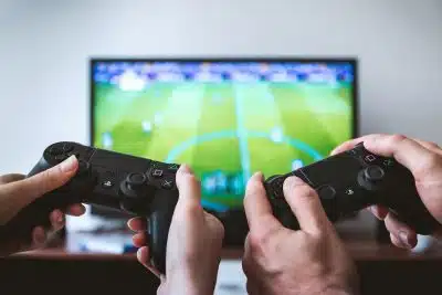 two people playing Sony PS4 game console